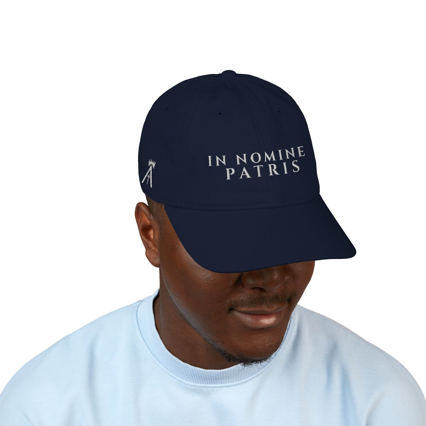 Agnus Co. In Nomine Patris navy Catholic cap worn by model — angled front view