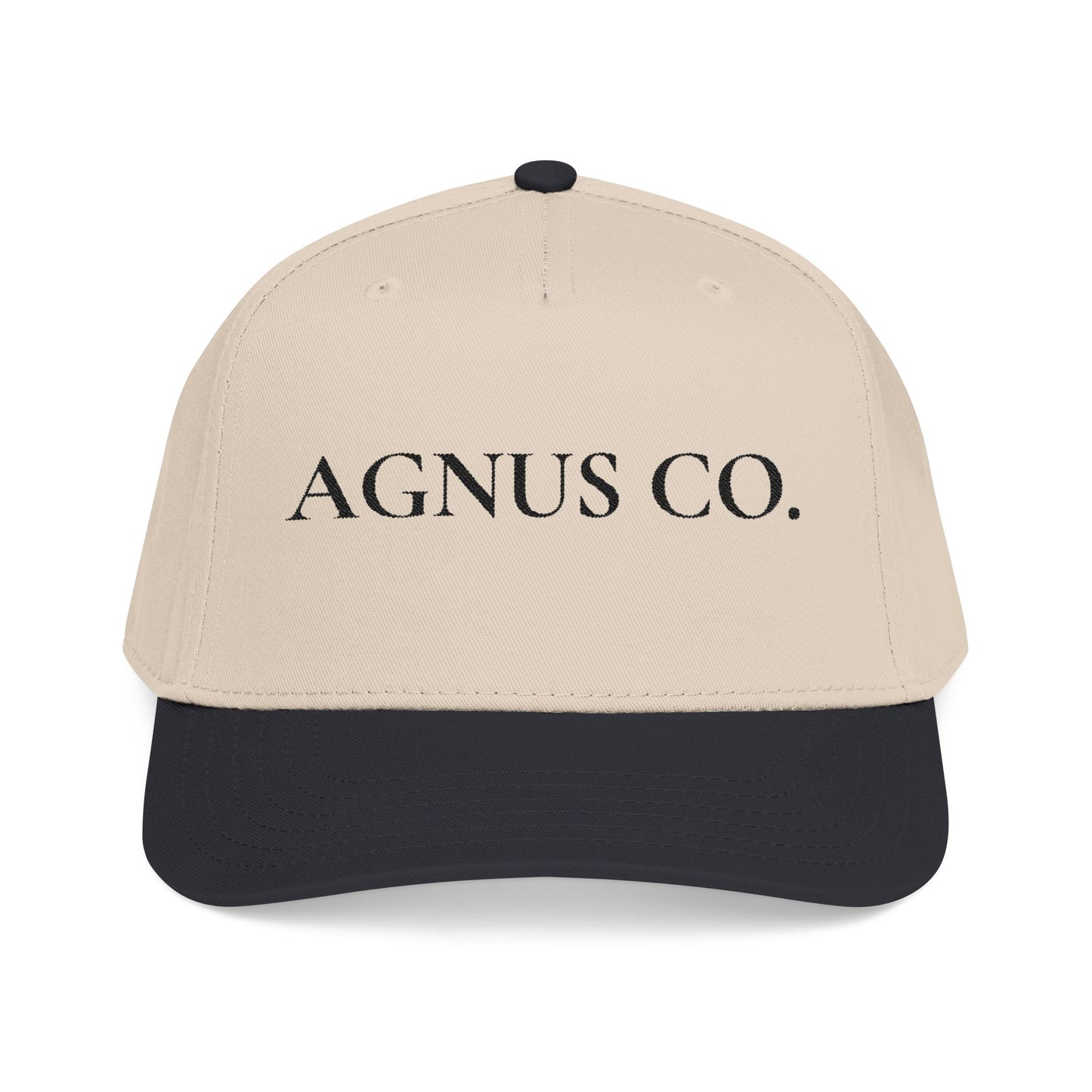 Agnus Co. Black and Natural two-tone Catholic cap — front view with Agnus Co. text embroidery
